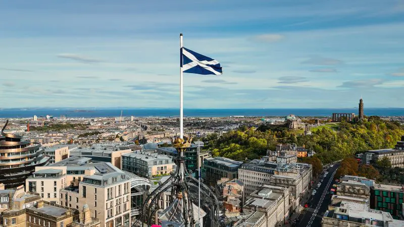 Aerial View Of Edinburgh Old Town, Aerial View Of The Scottish Flag In Edinburgh, Edinburgh City Centre, Gothic Revival Architecture In Scotland, Flag Of Scotland In Edinburgh